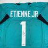 imageAutographedSigned Travis Etienne Jr Jacksonville Teal Football Jersey Beckett BAS COA